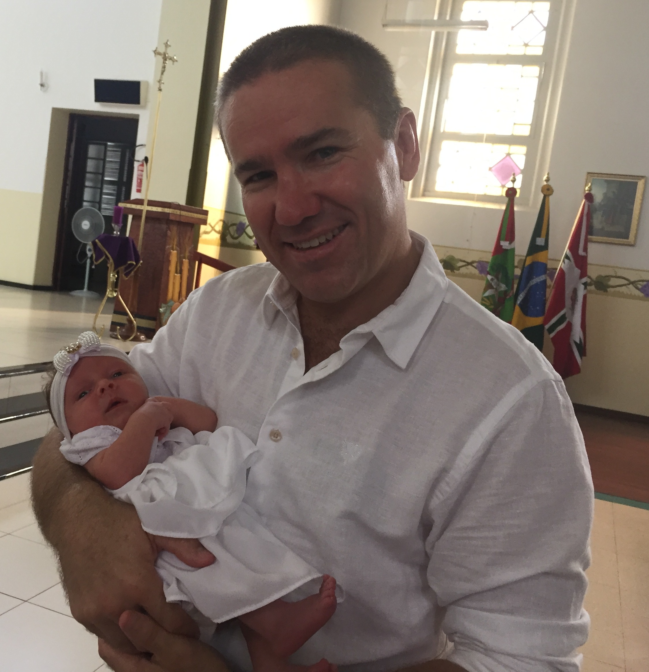 Steve Woollett holding Steve with his young daughter, celebrating their connection across two continents
